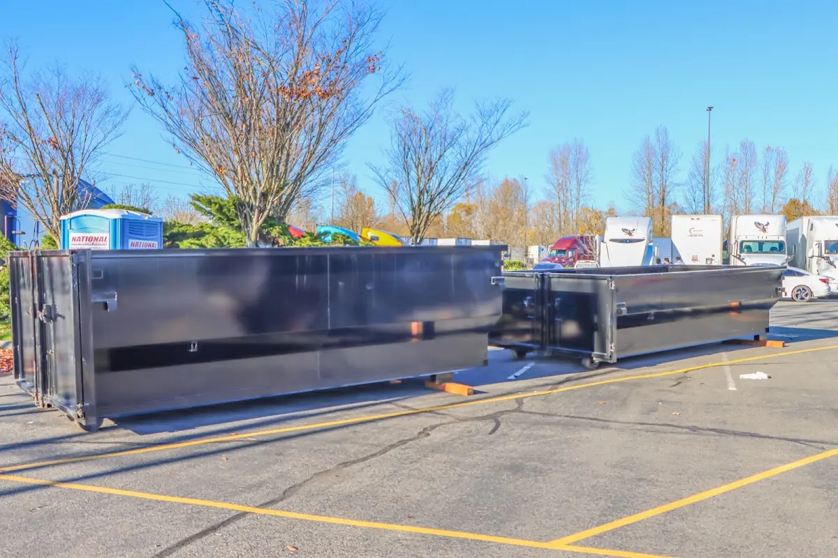 Professional dumpster rental service with roll-off container on residential driveway in Sulphur